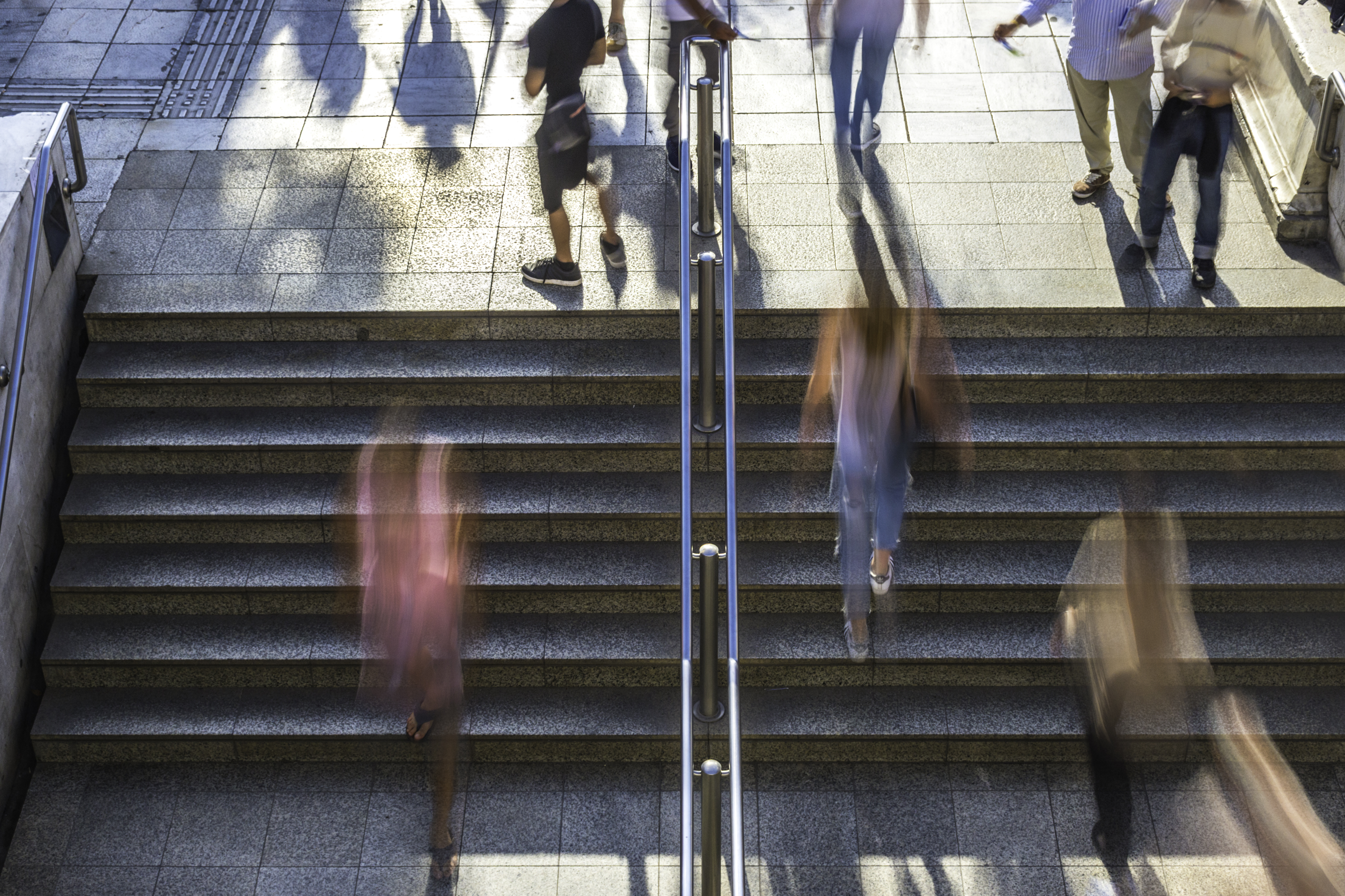 Image of blurry people leaving building