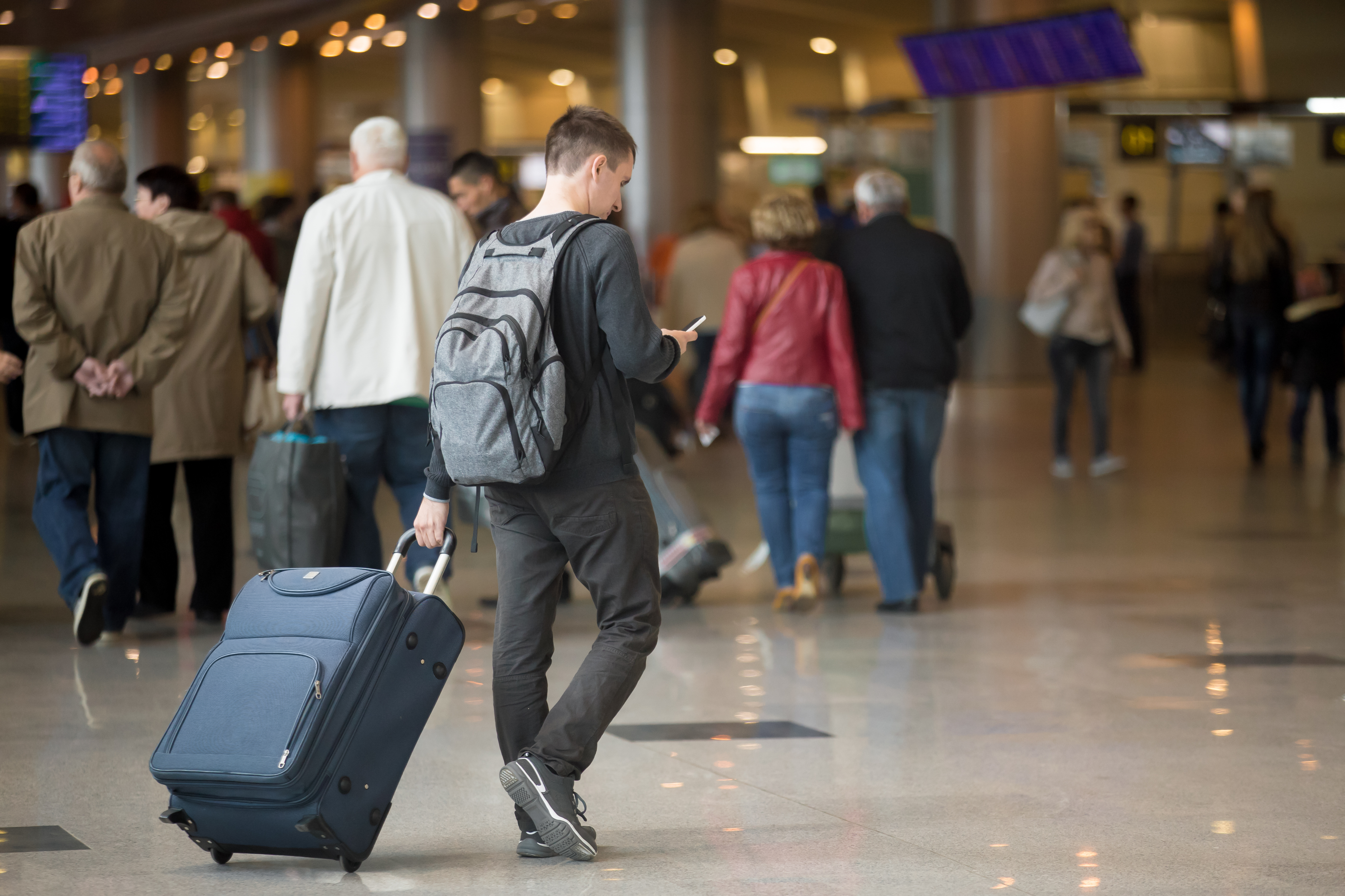 Someone walking with their suitcase abroad