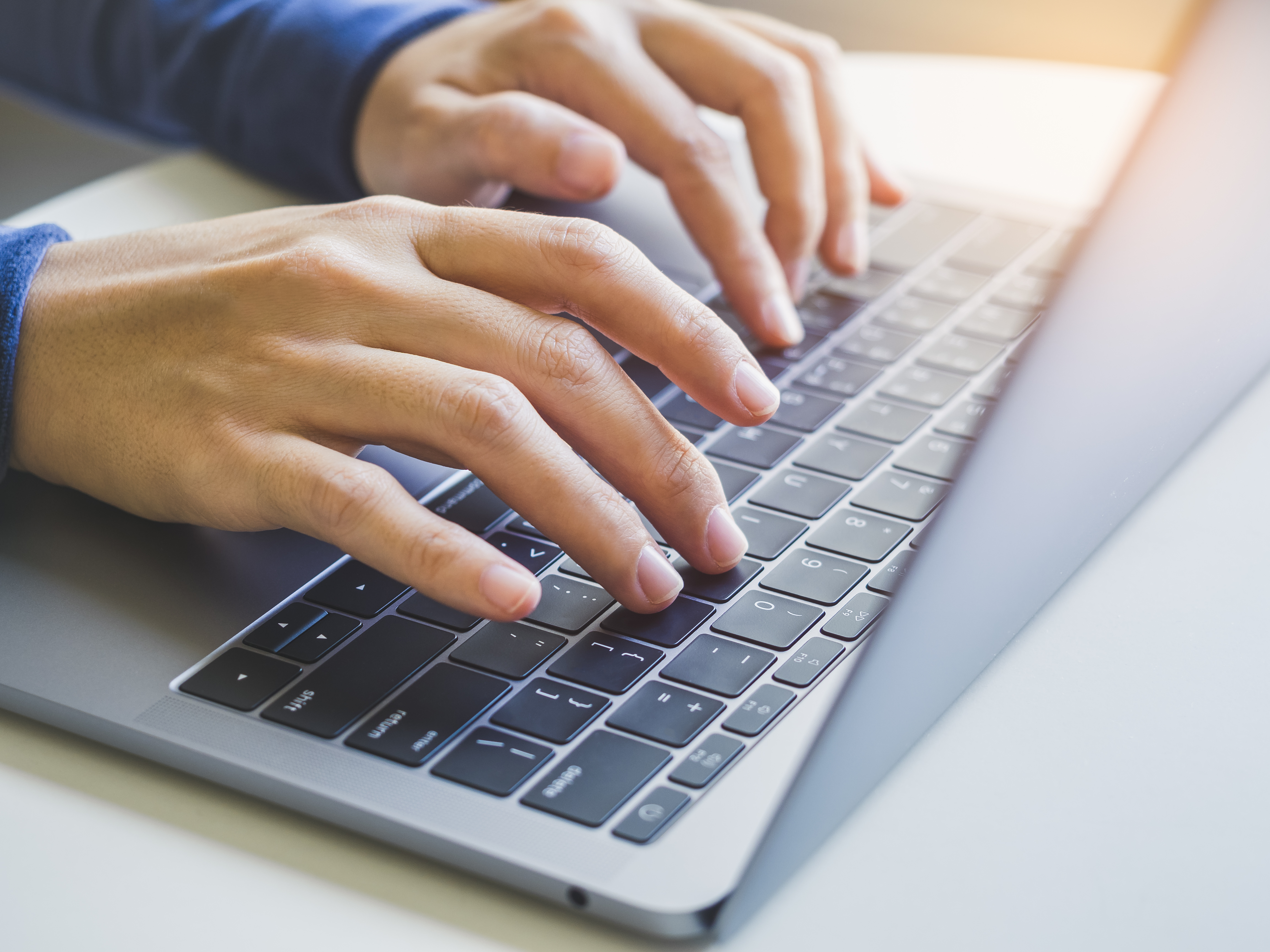 Person typing on a laptop