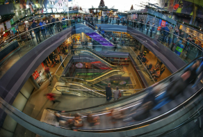 Busy shopping centre showing people on escalators